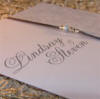 Silver edged folded wedding invitation with ribbon and beading detail