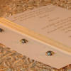 Beaded flowers with ribbon detail wedding invitation